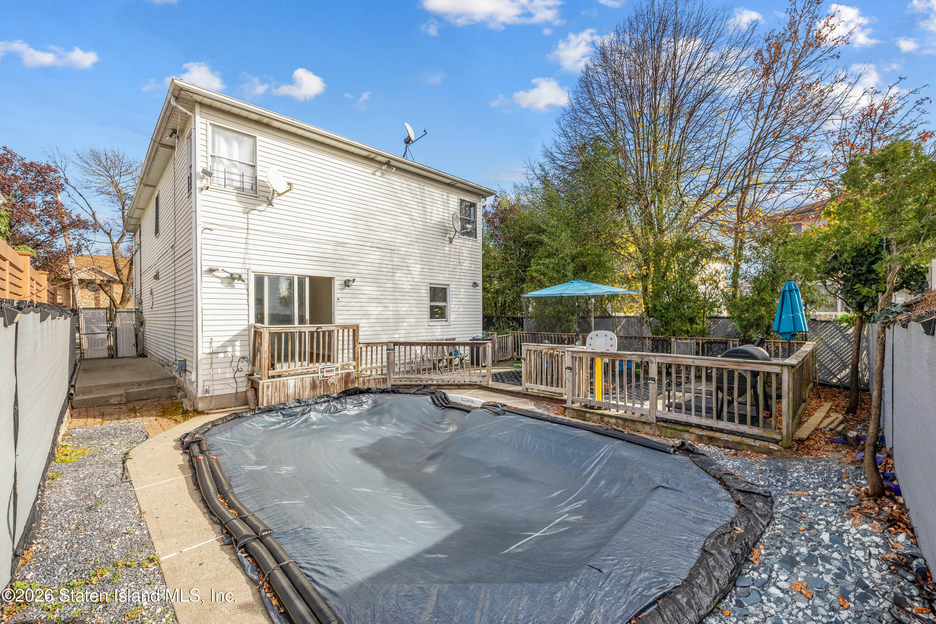 62 Bennett Place Staten Island, NY 10312 - Photo 11 of 34 a view of a house with backyard and sitting area