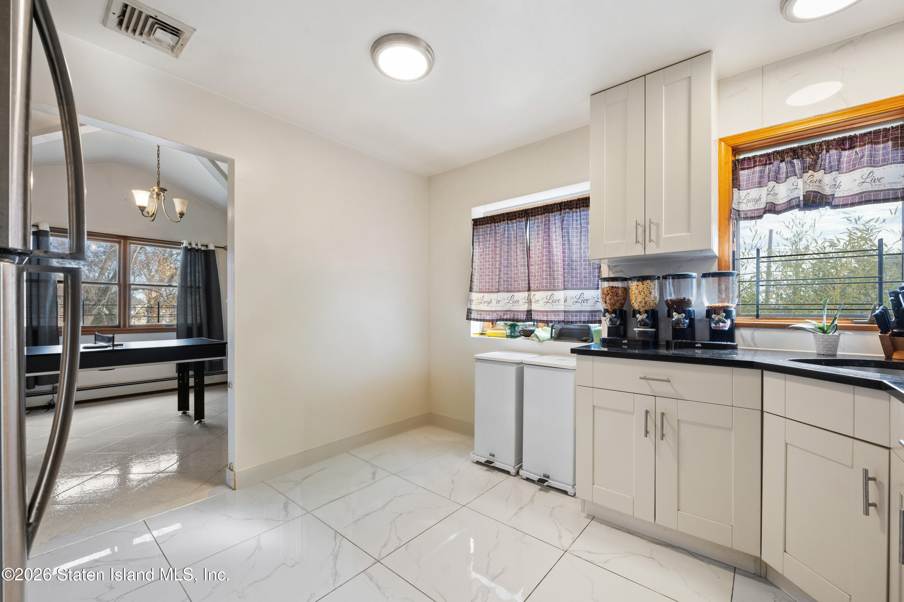 62 Bennett Place Staten Island, NY 10312 - Photo 17 of 34 a kitchen with white cabinets a sink and appliances