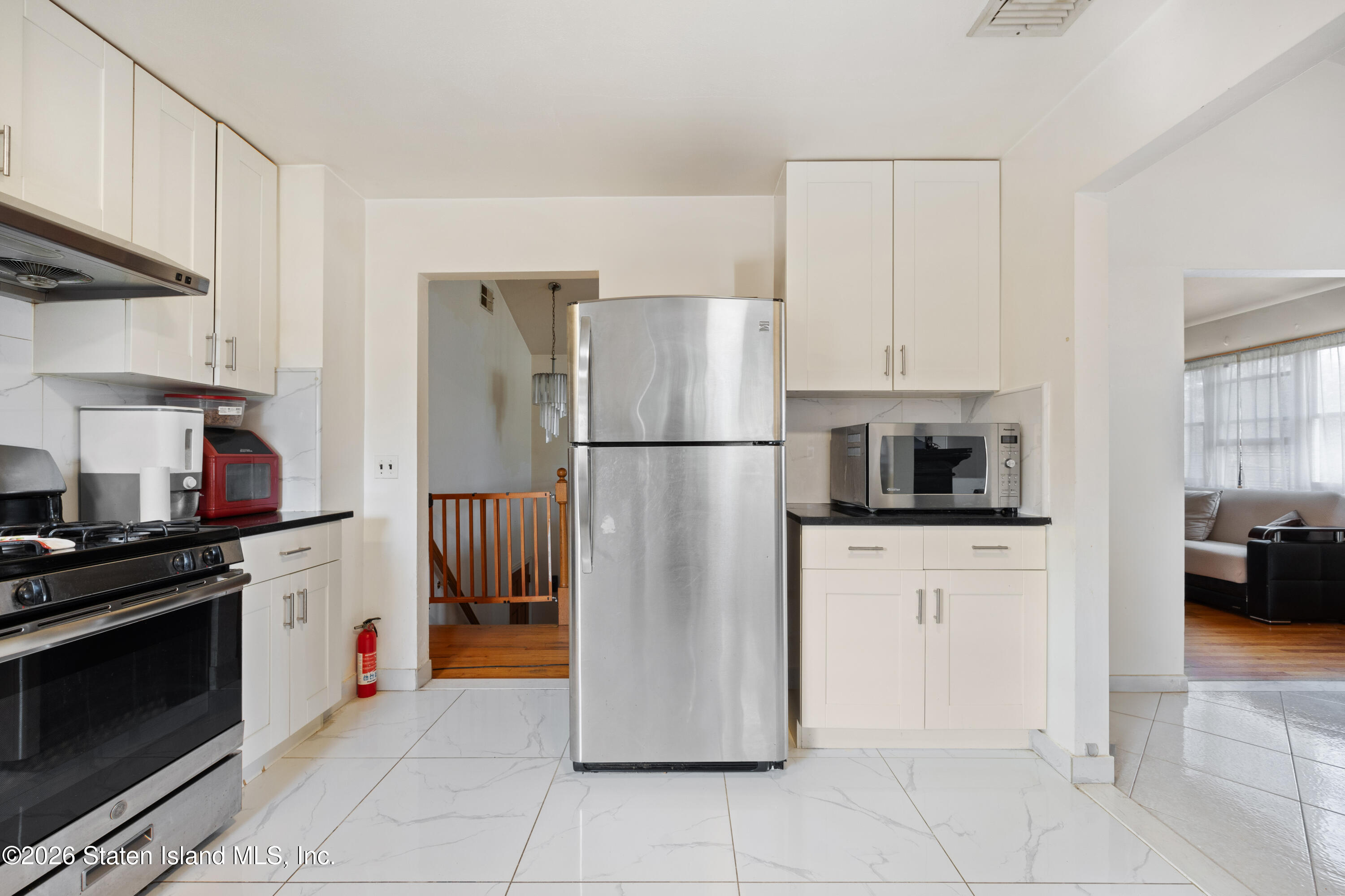 62 Bennett Place Staten Island, NY 10312 - Photo 19 of 34 a kitchen with stainless steel appliances granite countertop a refrigerator and a stove top oven