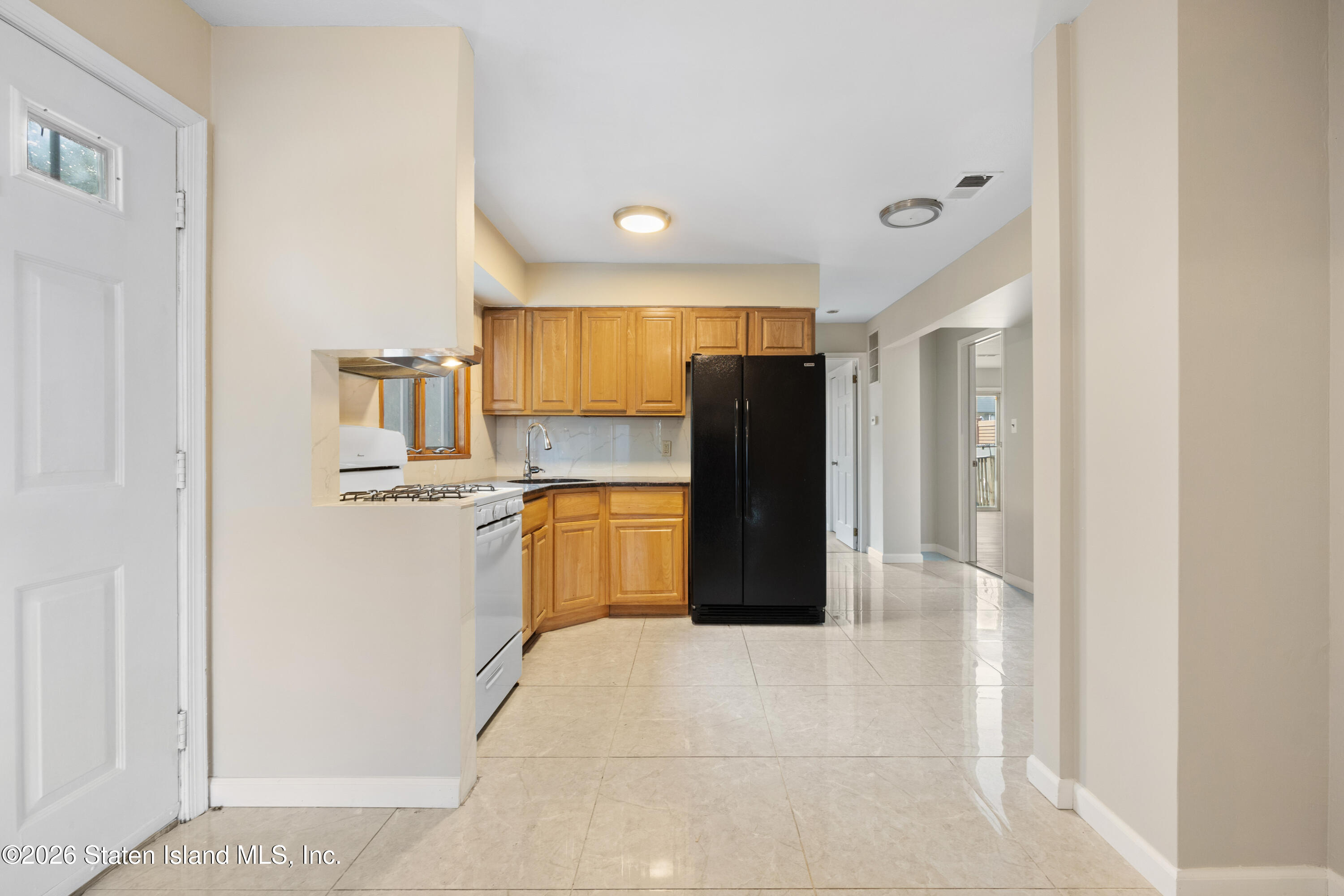 62 Bennett Place Staten Island, NY 10312 - Photo 2 of 34 a kitchen with refrigerator and window