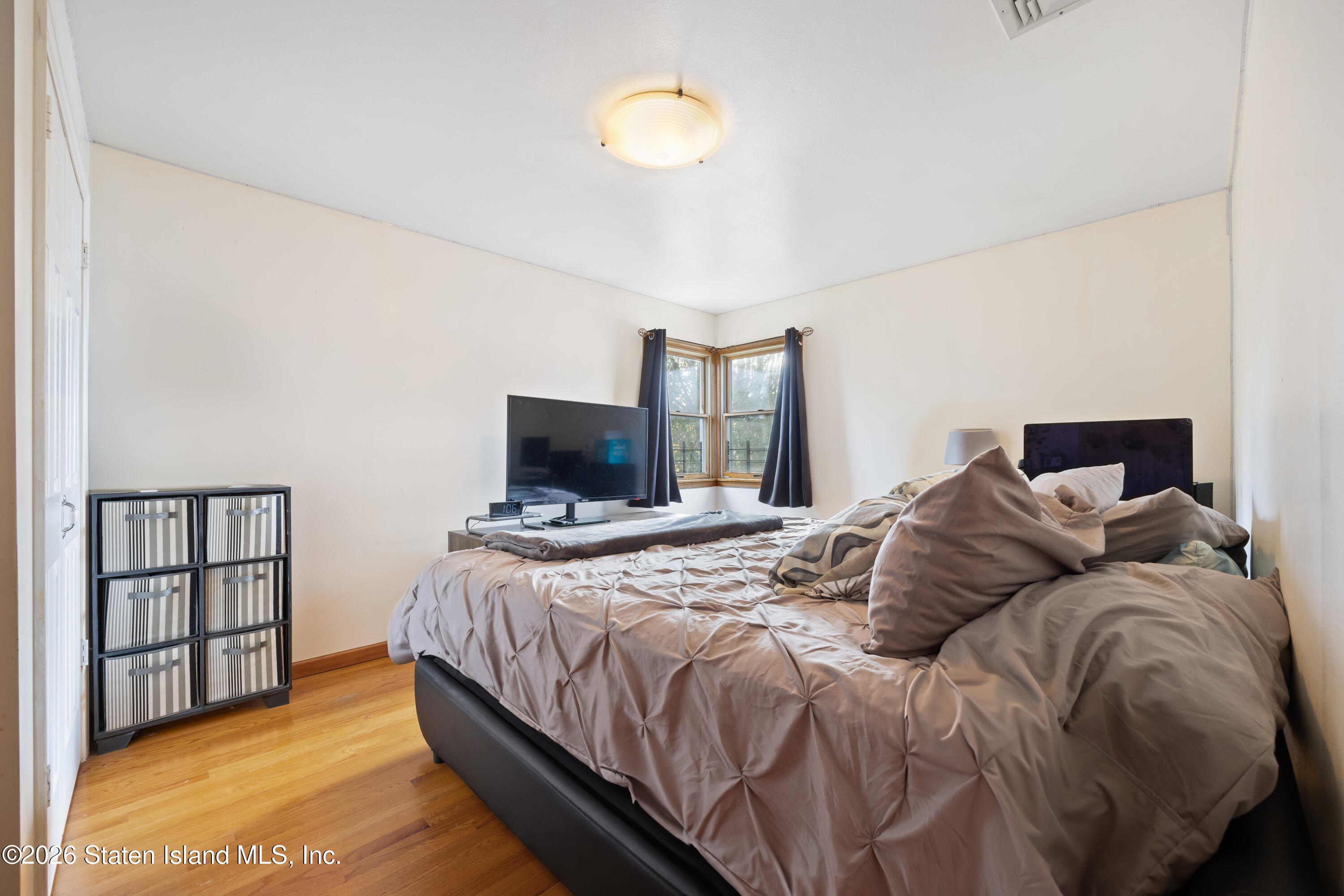 62 Bennett Place Staten Island, NY 10312 - Photo 21 of 34 a bedroom with a bed and a tv