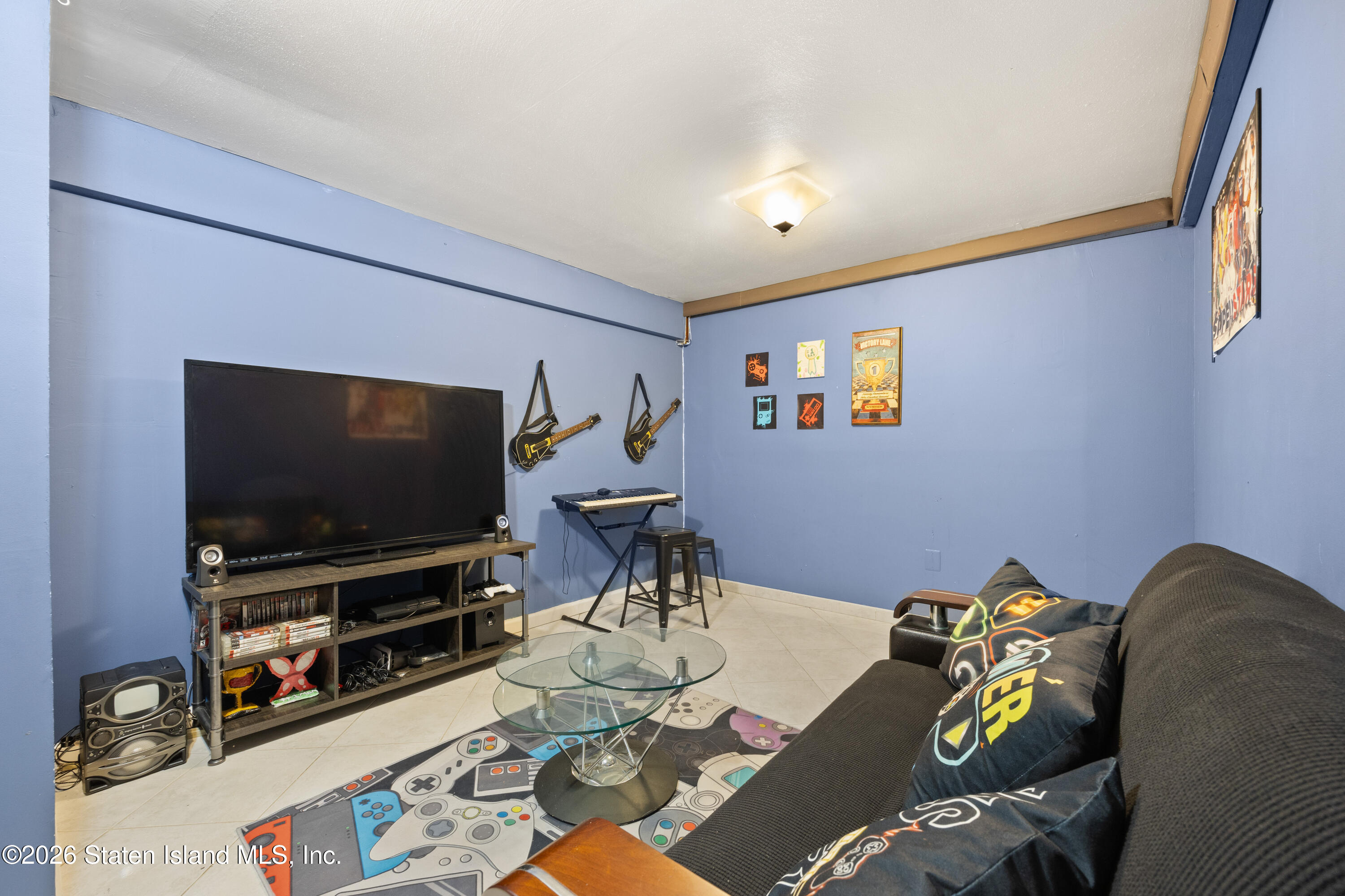 62 Bennett Place Staten Island, NY 10312 - Photo 25 of 34 a living room with furniture and a flat screen tv