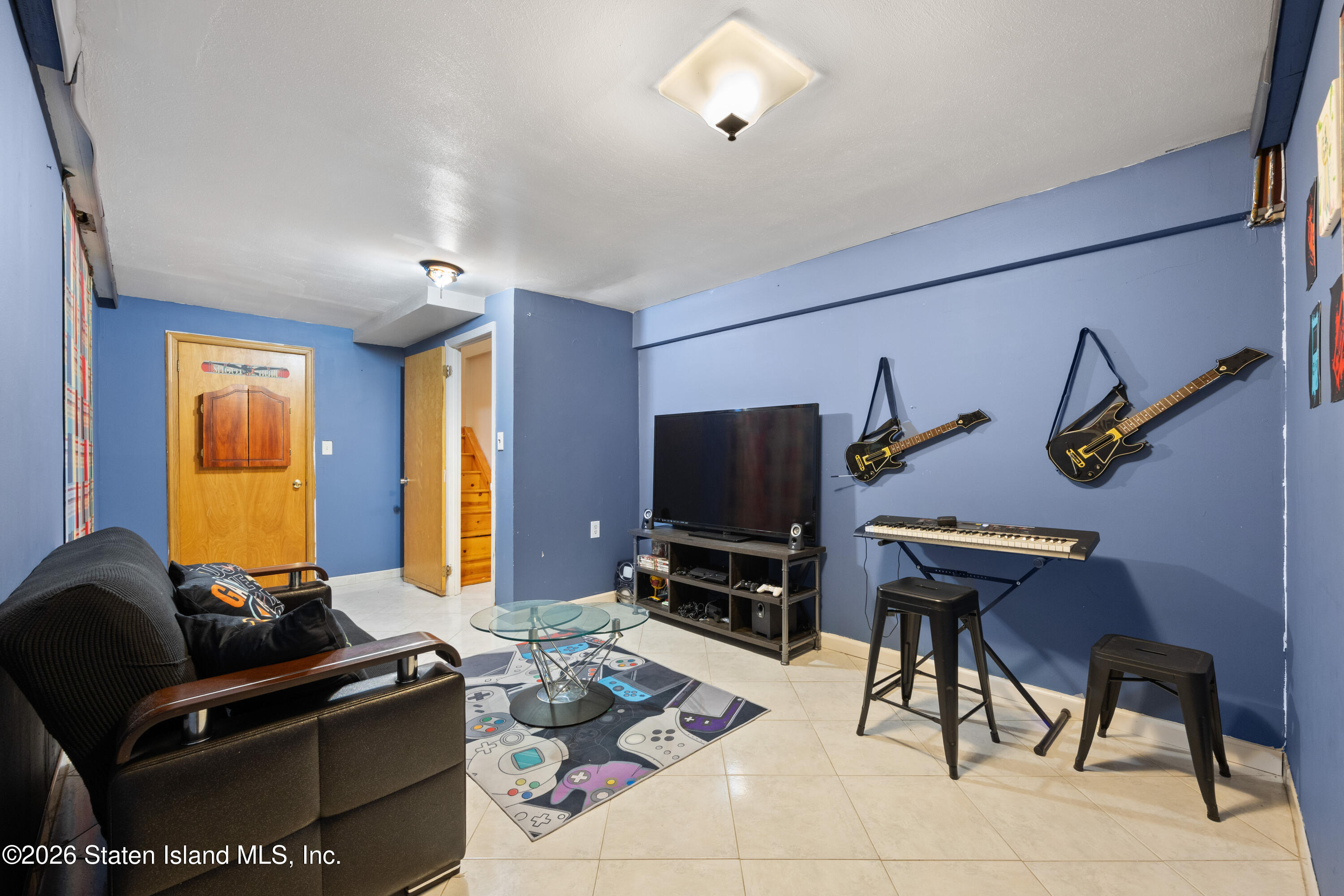 62 Bennett Place Staten Island, NY 10312 - Photo 26 of 34 a living room with furniture a flat screen tv and a window