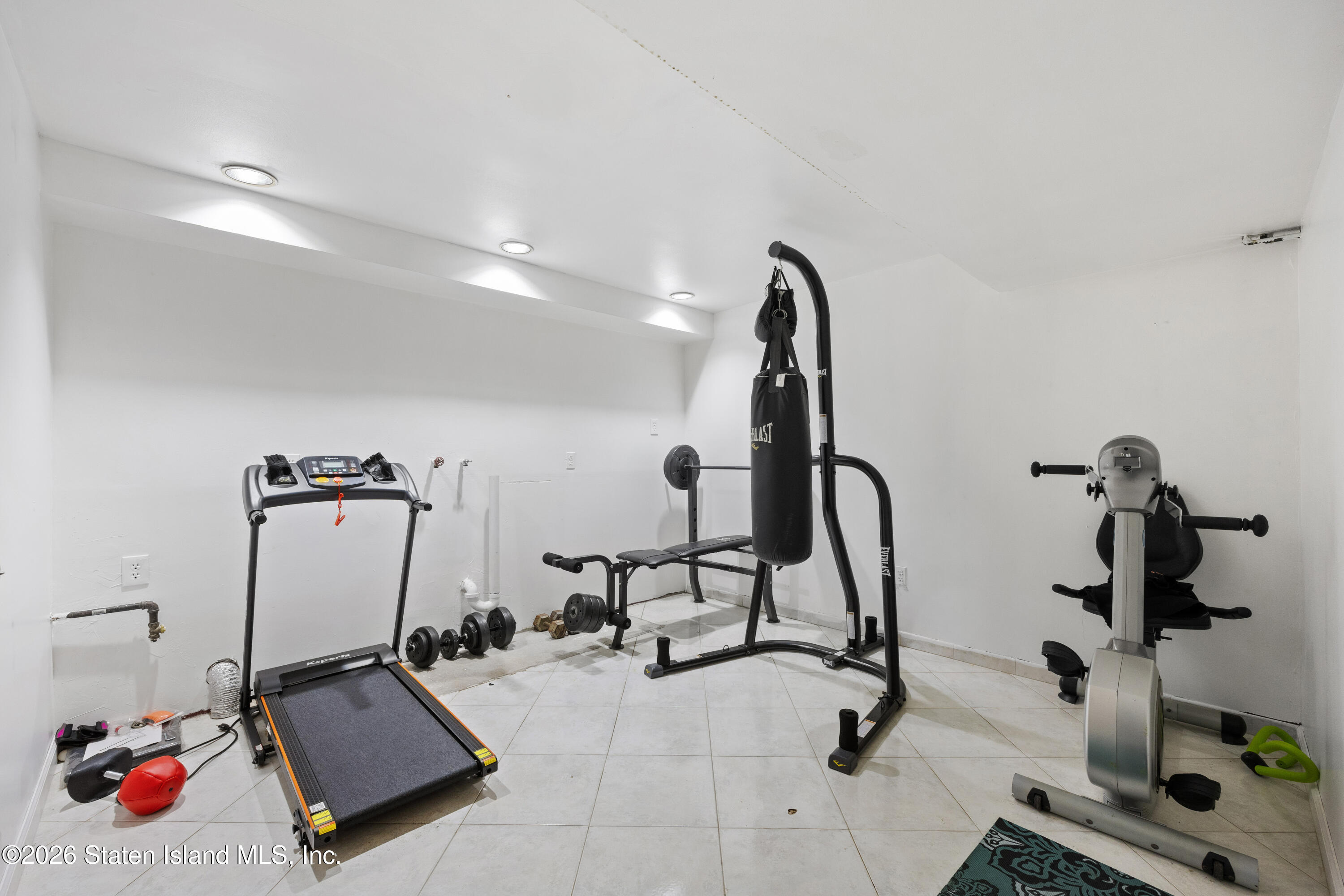 62 Bennett Place Staten Island, NY 10312 - Photo 27 of 34 a room with gym equipment and mirrors