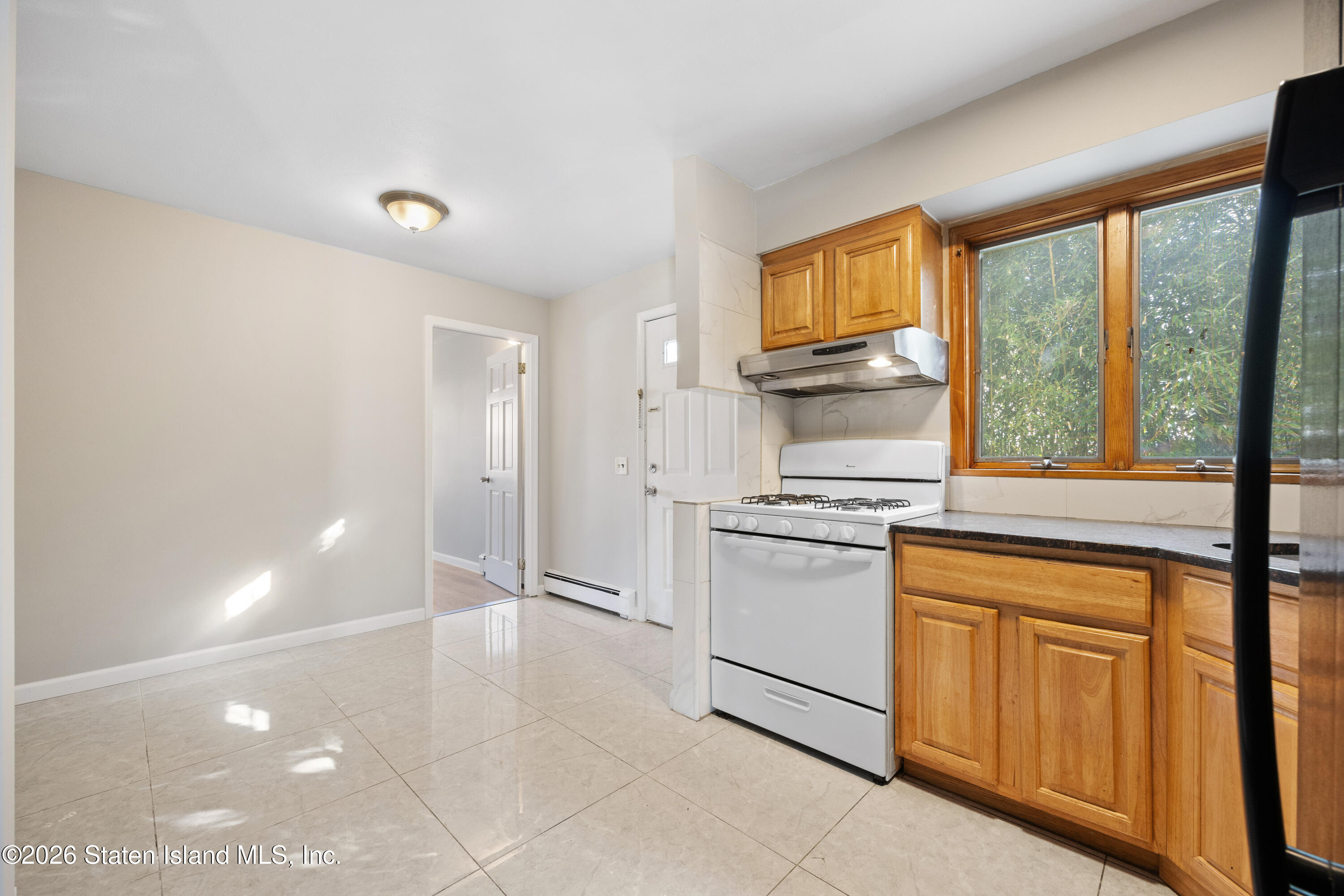 62 Bennett Place Staten Island, NY 10312 - Photo 3 of 34 a kitchen with stainless steel appliances granite countertop a stove a sink and a refrigerator