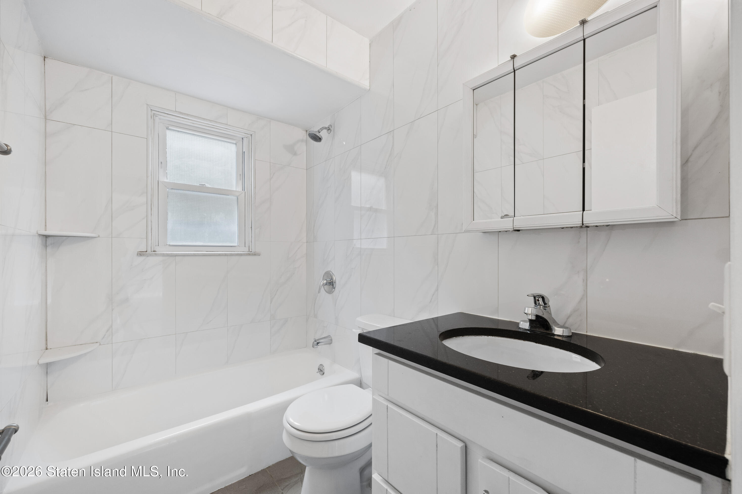 62 Bennett Place Staten Island, NY 10312 - Photo 4 of 34 a bathroom with a sink a toilet and bathtub