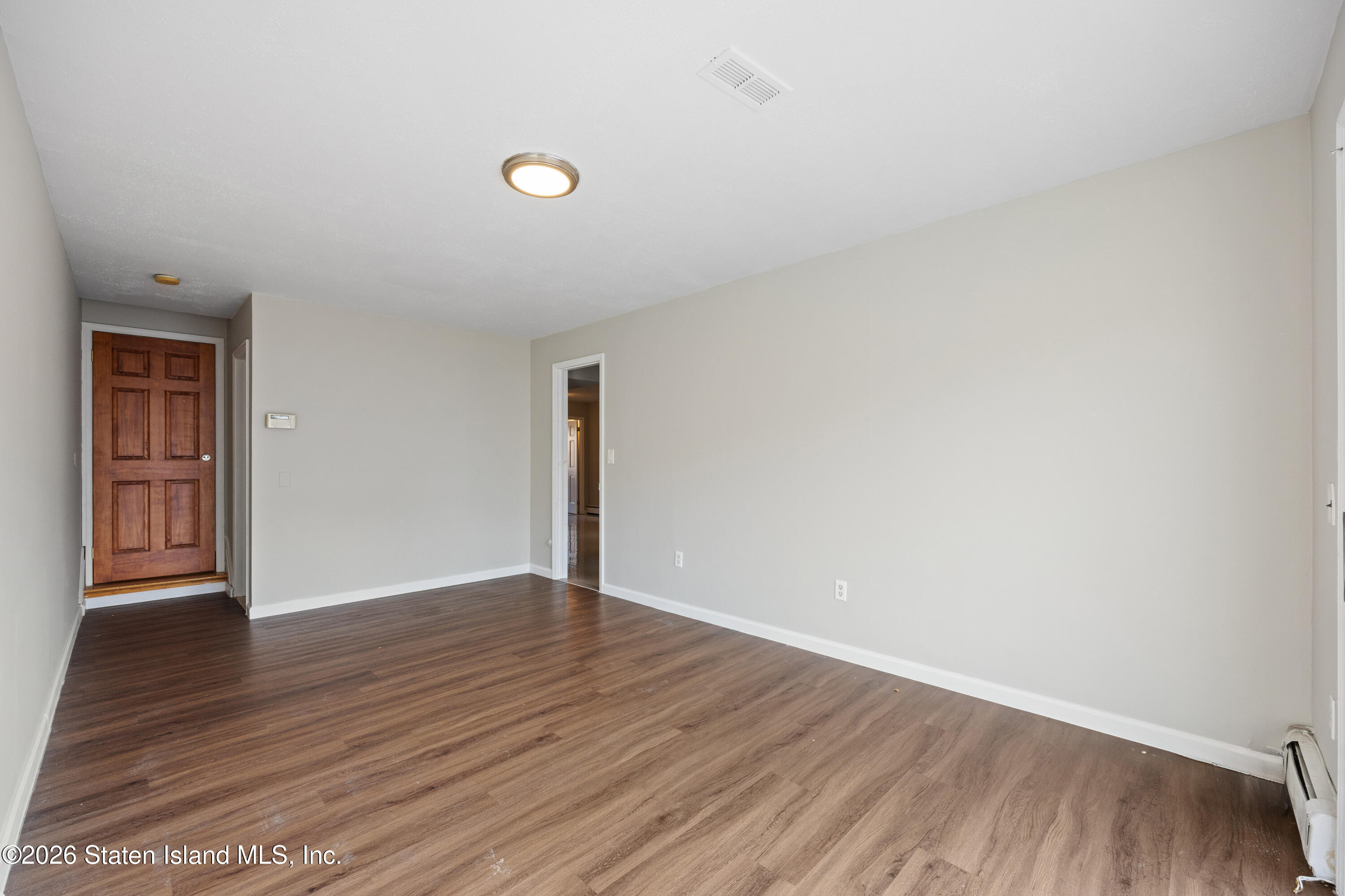 62 Bennett Place Staten Island, NY 10312 - Photo 8 of 34 an empty room with wooden floor and windows