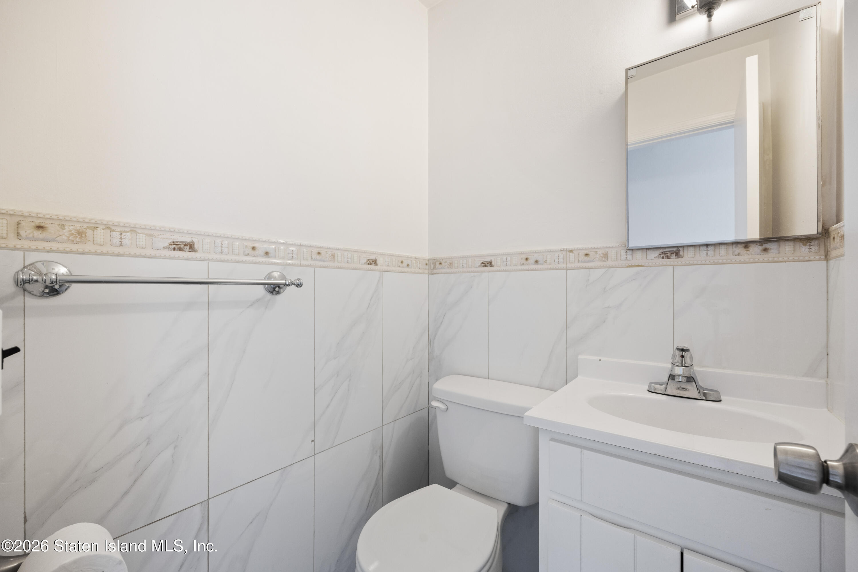 62 Bennett Place Staten Island, NY 10312 - Photo 9 of 34 a bathroom with a sink a toilet and shower