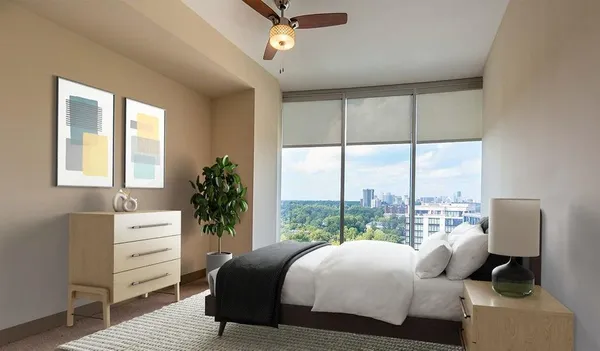 a bedroom with a bed and a window