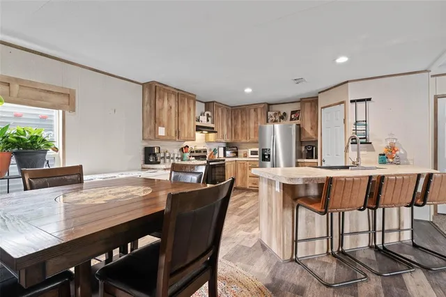 a dining table with chairs and kitchen view