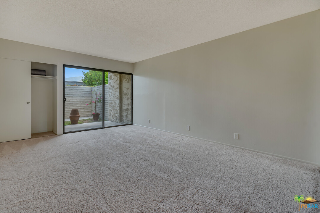 1111 East Ramon Road, Unit 69 Palm Springs, CA 92264 - Photo 9 of 20 an empty room with an outdoor view and a window