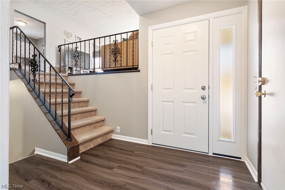 801 Netherwood Avenue Northwest Canton, OH 44708 - Photo 7 of 44 Foyer featuring lvt wood-style floors and a textured ceiling