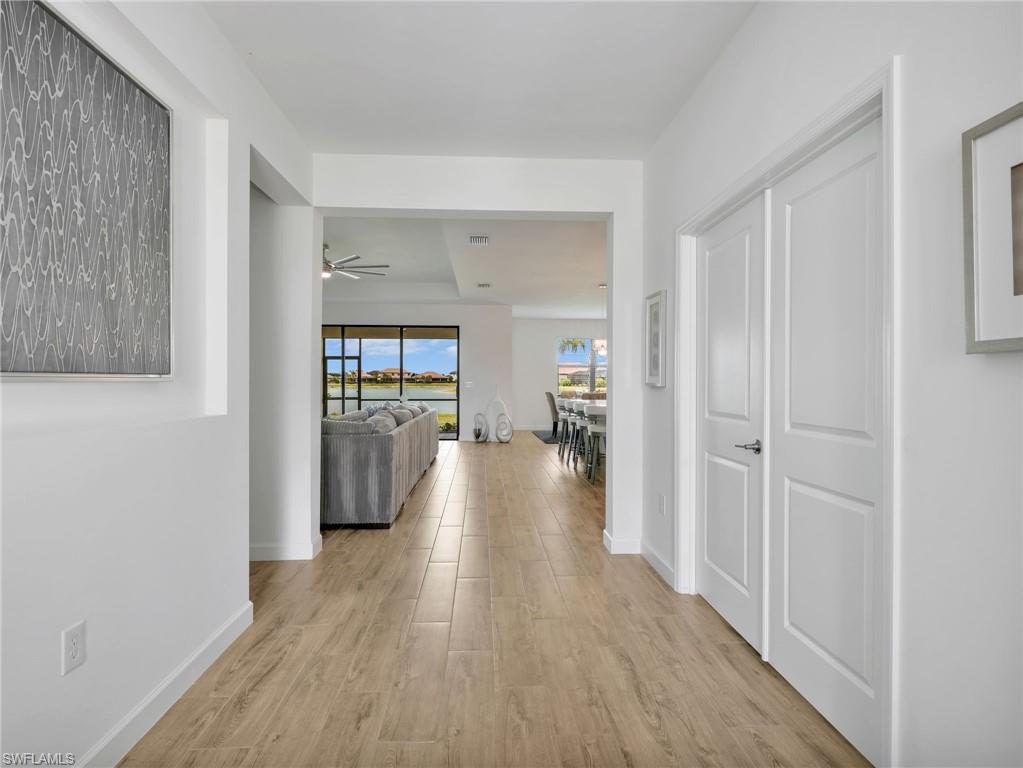 18278 Ridgeline Drive Estero, FL 33928 - Photo 3 of 45 a view of a hallway with wooden floor windows and a livingroom