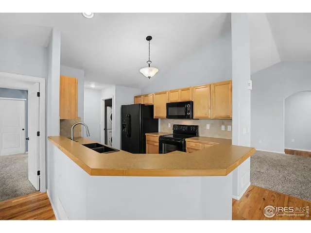 a kitchen with stainless steel appliances a stove a microwave a sink and cabinets