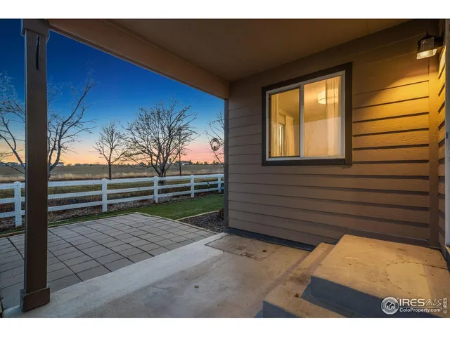 a view of a kitchen with kitchen island a sink wooden floor and a refrigerator