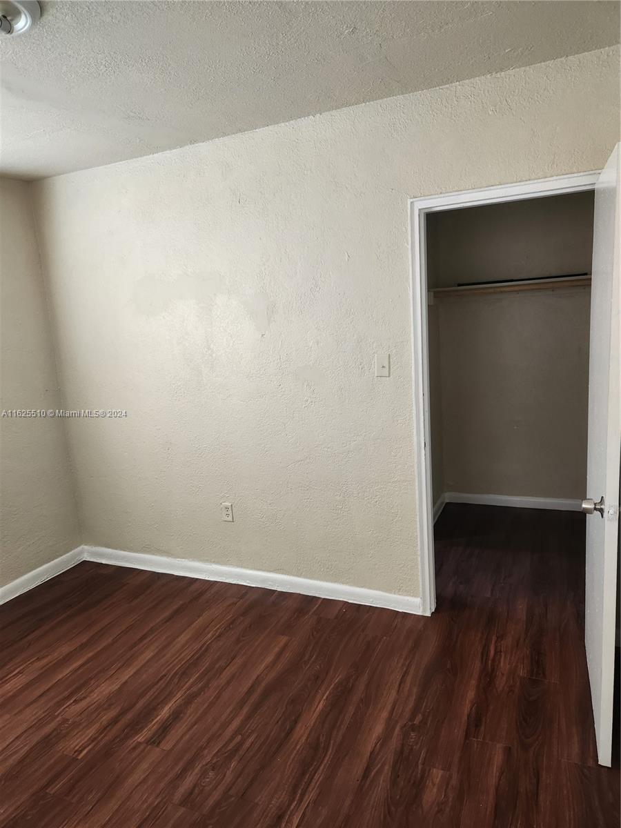 225 Northwest 17th Street Miami, FL 33136 - Photo 11 of 11 a view of a small space with wooden floor and a window