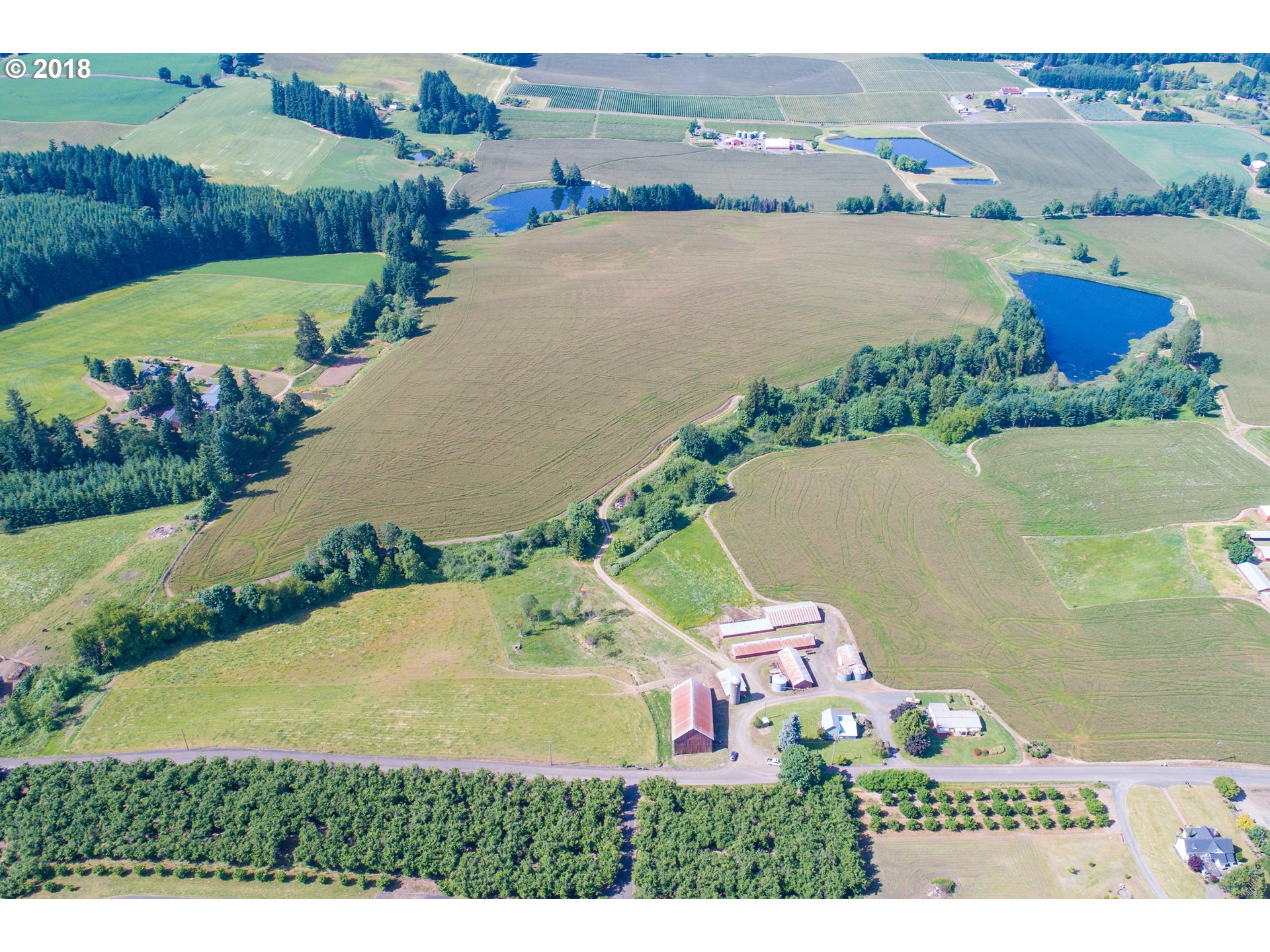 33555 Southwest Firdale Road Cornelius, OR 97113 - Photo 1 of 23 an aerial view of a house with a garden and lake view
