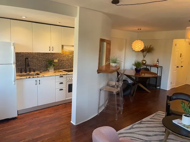 a view of a livingroom with furniture and wooden floor