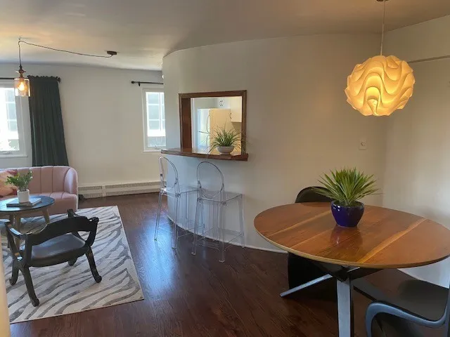 a view of a dining room with furniture and wooden floor