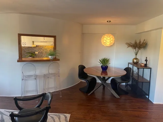 a living room with couches chairs and a potted plant