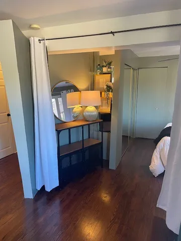 a bedroom with a bed and a mirror