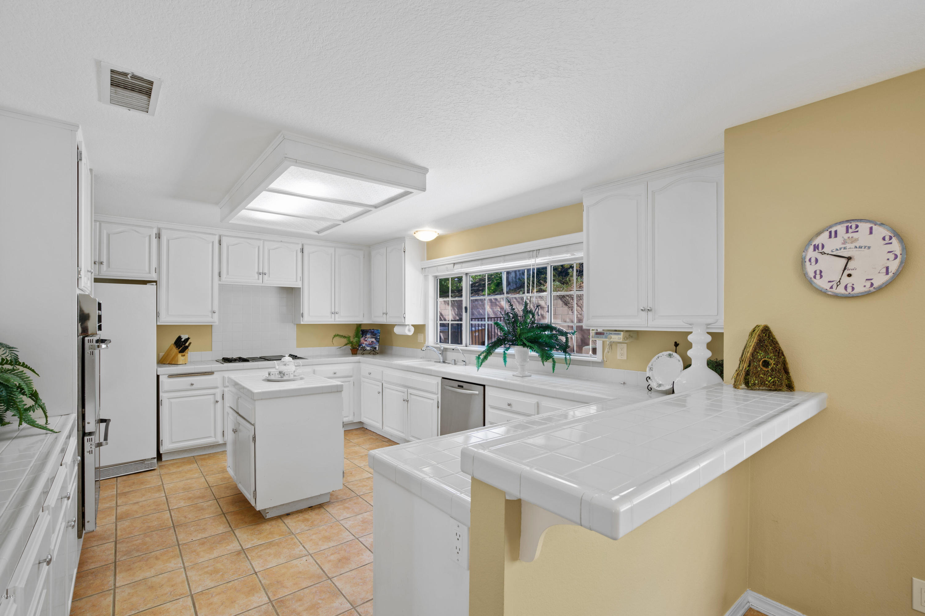 6670 Armitos Drive Camarillo, CA 93012 - Photo 11 of 35 a kitchen with a sink a stove and chairs
