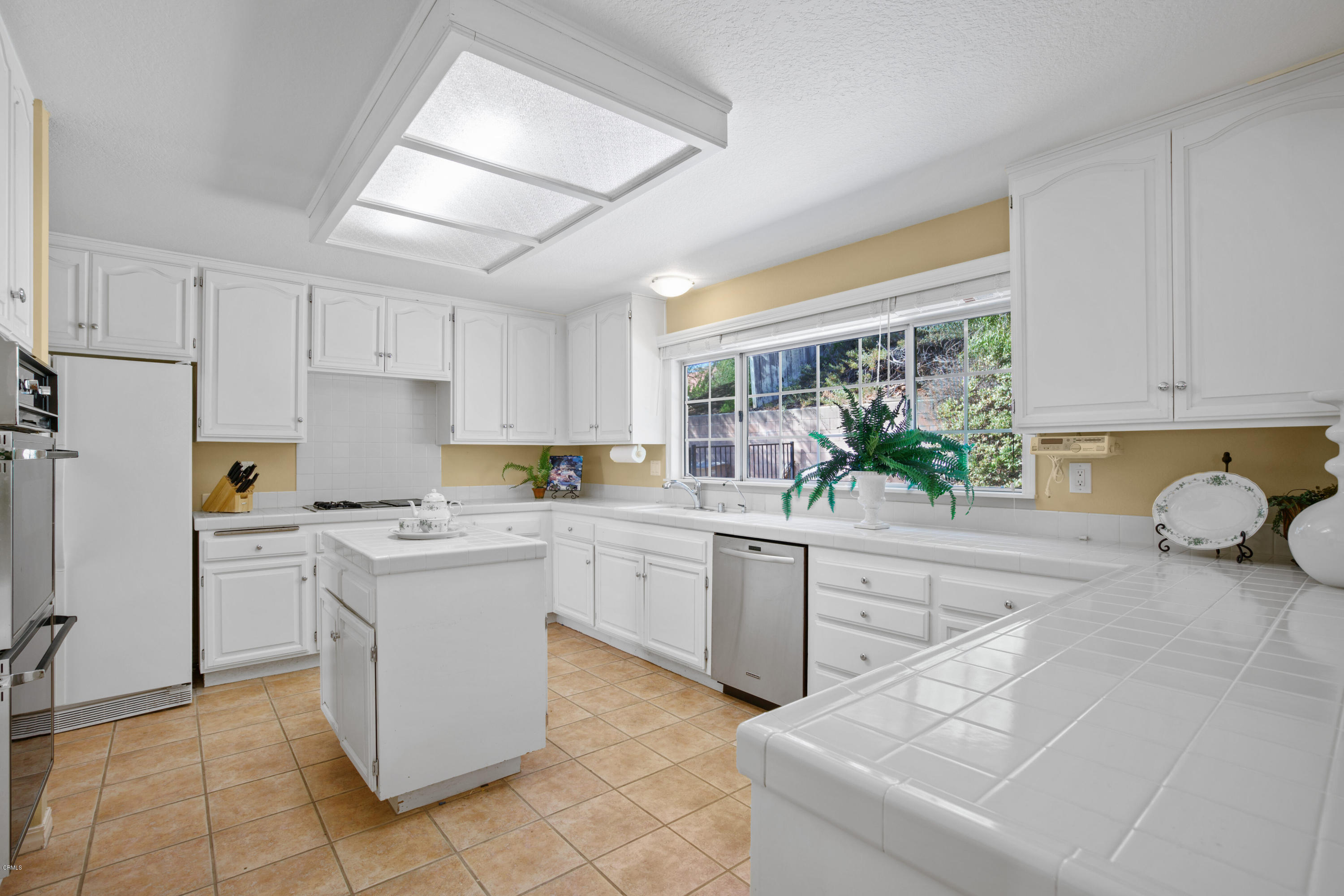 6670 Armitos Drive Camarillo, CA 93012 - Photo 12 of 35 a kitchen with a sink window and cabinets
