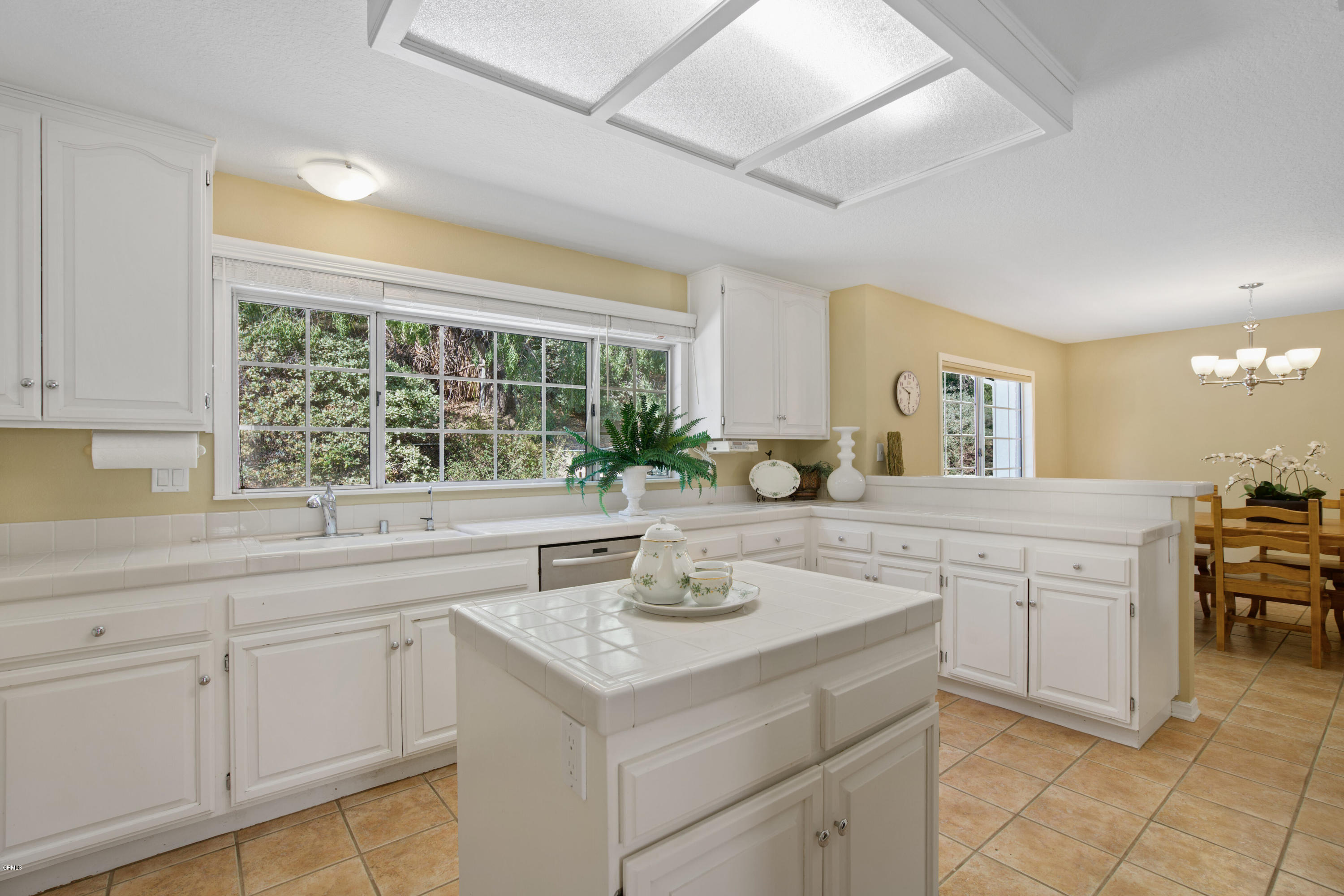6670 Armitos Drive Camarillo, CA 93012 - Photo 13 of 35 a kitchen with sink cabinets and dining table