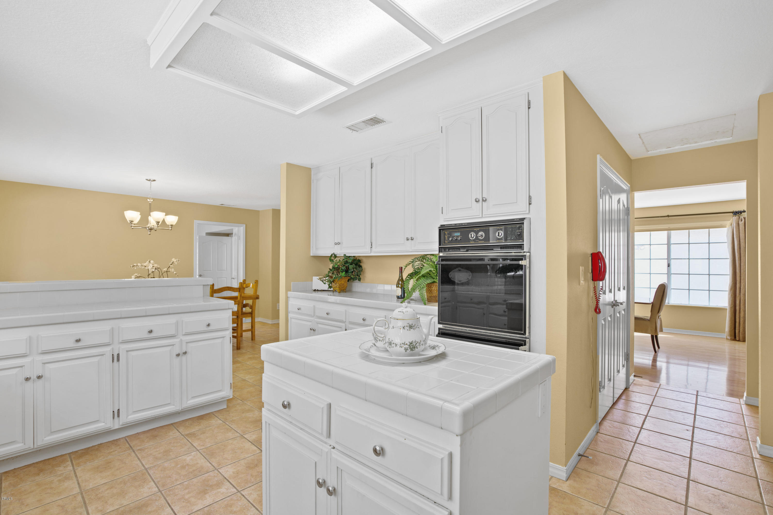 6670 Armitos Drive Camarillo, CA 93012 - Photo 15 of 35 a kitchen with granite countertop white cabinets and white appliances