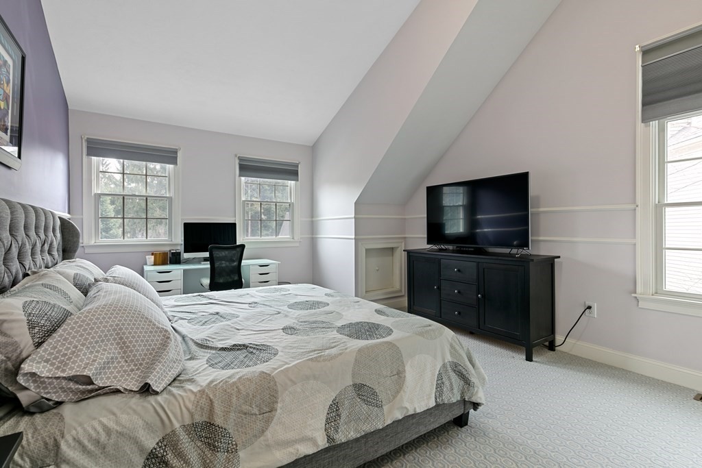9 Chestnut Lane, Unit 9 Lexington, MA 02421 - Photo 14 of 32 a bedroom with a bed and a flat screen tv