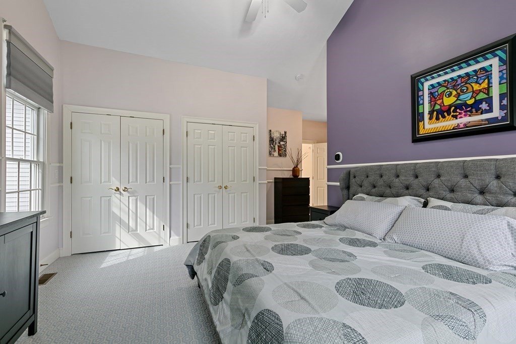 9 Chestnut Lane, Unit 9 Lexington, MA 02421 - Photo 15 of 32 a bedroom with a bed and a painting on the wall