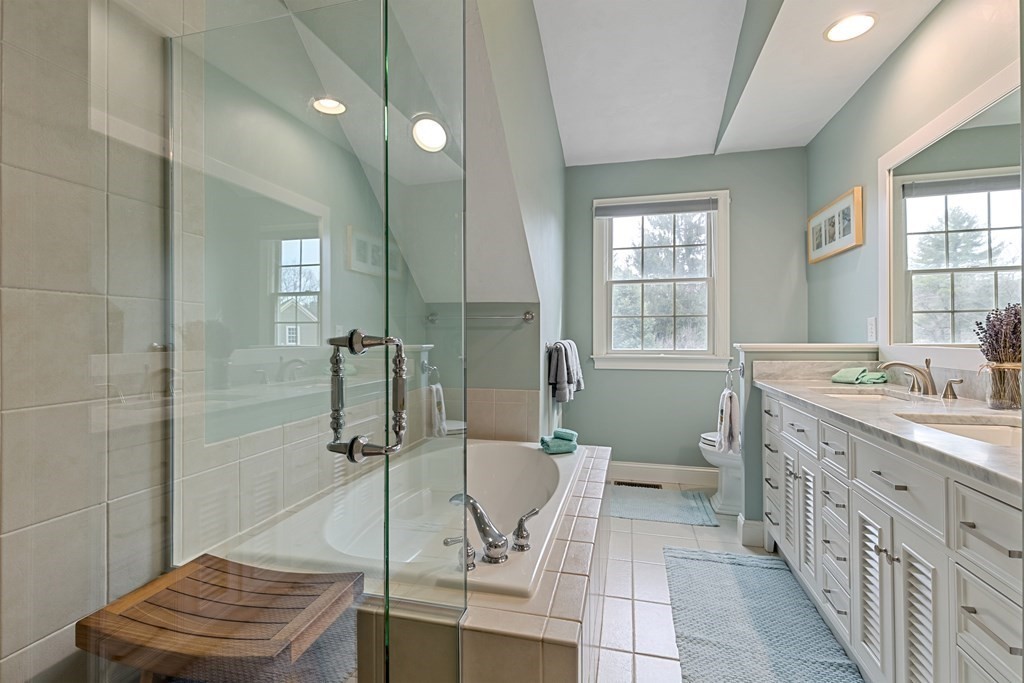 9 Chestnut Lane, Unit 9 Lexington, MA 02421 - Photo 17 of 32 a spacious bathroom with a double vanity sink a mirror and a shower