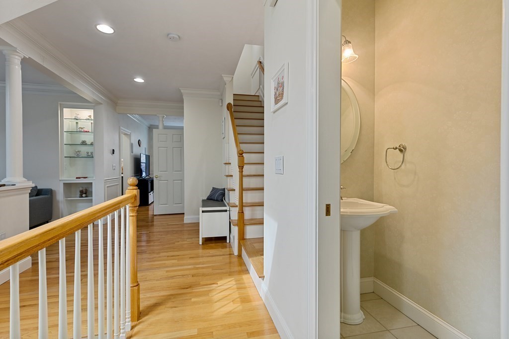 9 Chestnut Lane, Unit 9 Lexington, MA 02421 - Photo 20 of 32 a view of a hallway with wooden floor and staircase