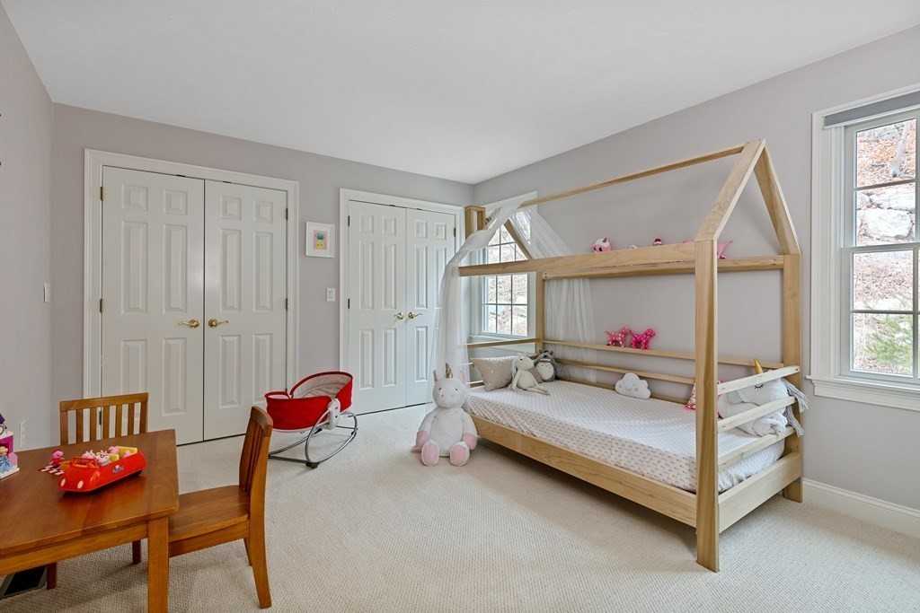 9 Chestnut Lane, Unit 9 Lexington, MA 02421 - Photo 21 of 32 a white bed sitting in a bedroom next to a window