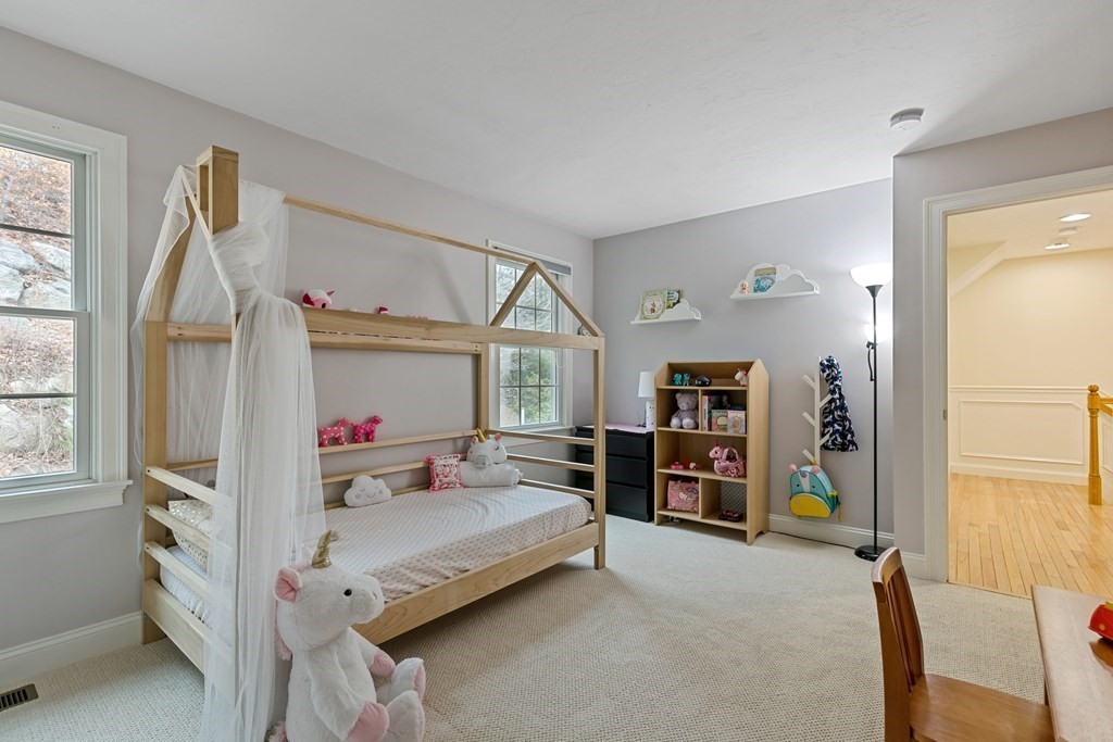 9 Chestnut Lane, Unit 9 Lexington, MA 02421 - Photo 22 of 32 a bedroom with a bed and a window