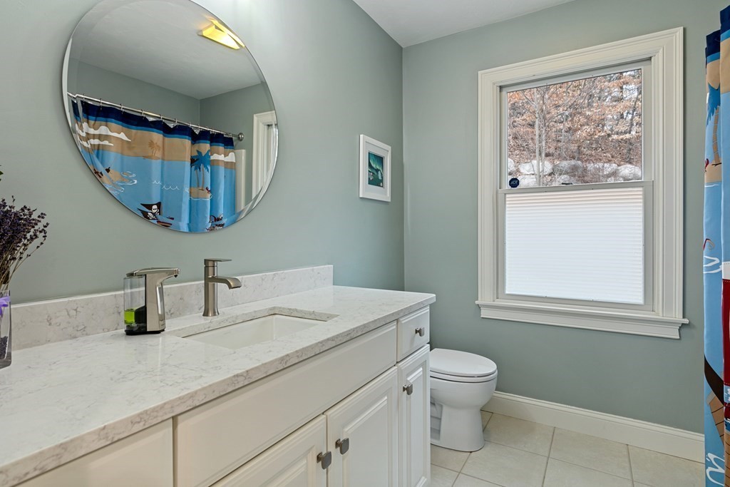 9 Chestnut Lane, Unit 9 Lexington, MA 02421 - Photo 28 of 32 a bathroom with a toilet a sink and mirror