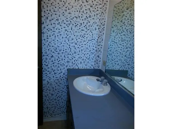 a bathroom with a sink and a shower