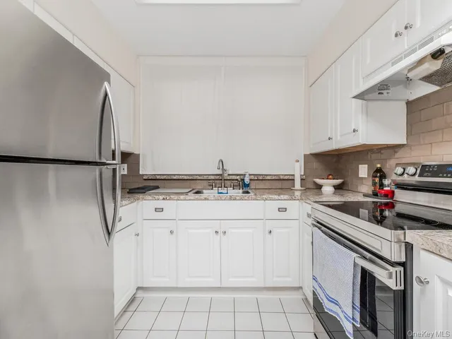 a kitchen with a sink cabinets and appliances