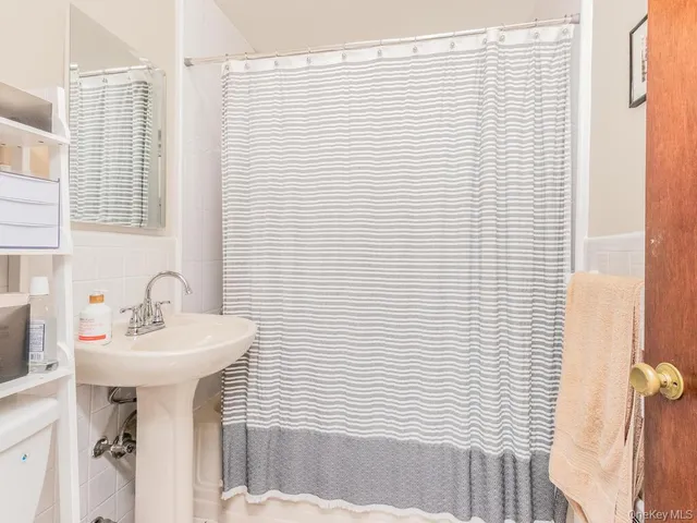 a bathroom with a sink a mirror and a shower