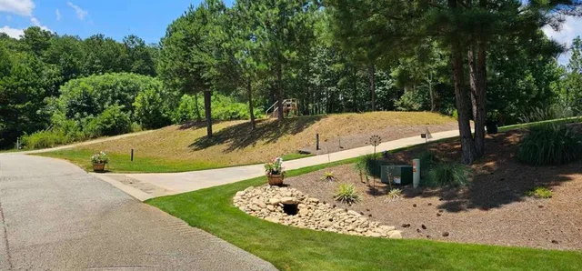 a view of a swimming pool with a yard