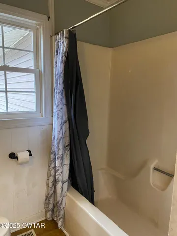 a bathroom with a shower and a toilet