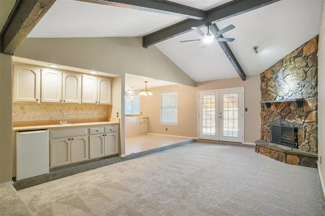 a spacious bathroom with a granite countertop sink mirror and a bathtub