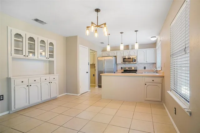 a kitchen with stainless steel appliances a refrigerator sink and microwave