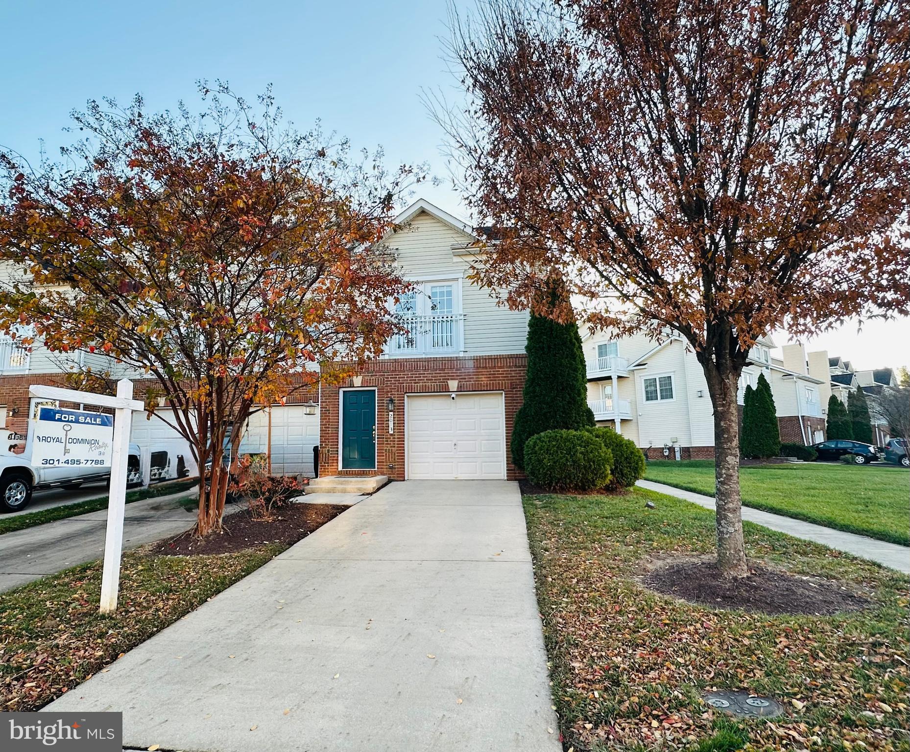 a front view of a house with a yard and tree s