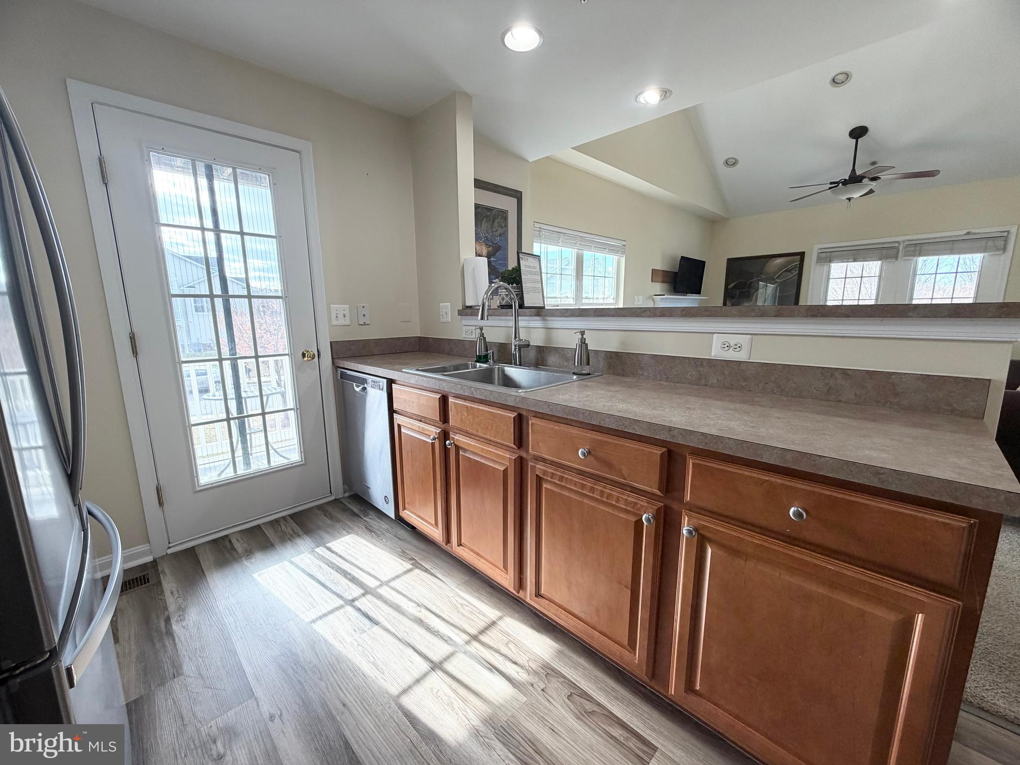 2013 Astilbe Way, Unit 2013 Odenton, MD 21113 - Photo 12 of 61 a kitchen with stainless steel appliances granite countertop a sink a stove wooden floor and a window