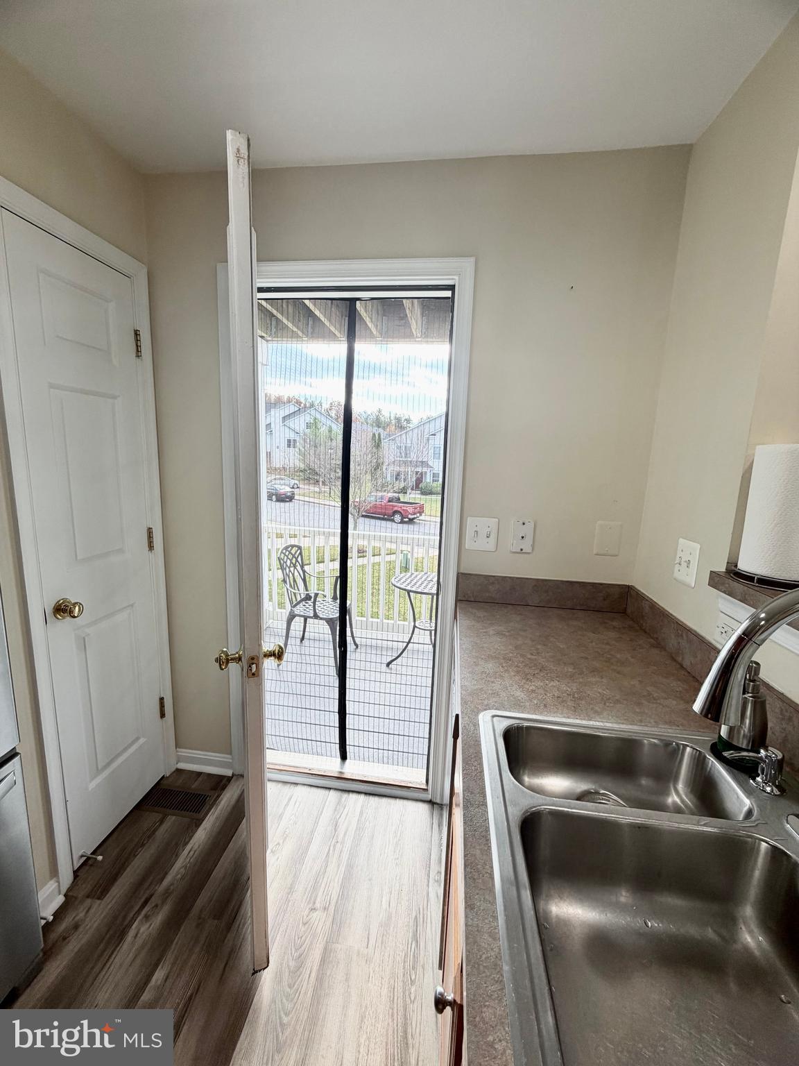 2013 Astilbe Way, Unit 2013 Odenton, MD 21113 - Photo 13 of 61 a hallway with a chair and wooden floor