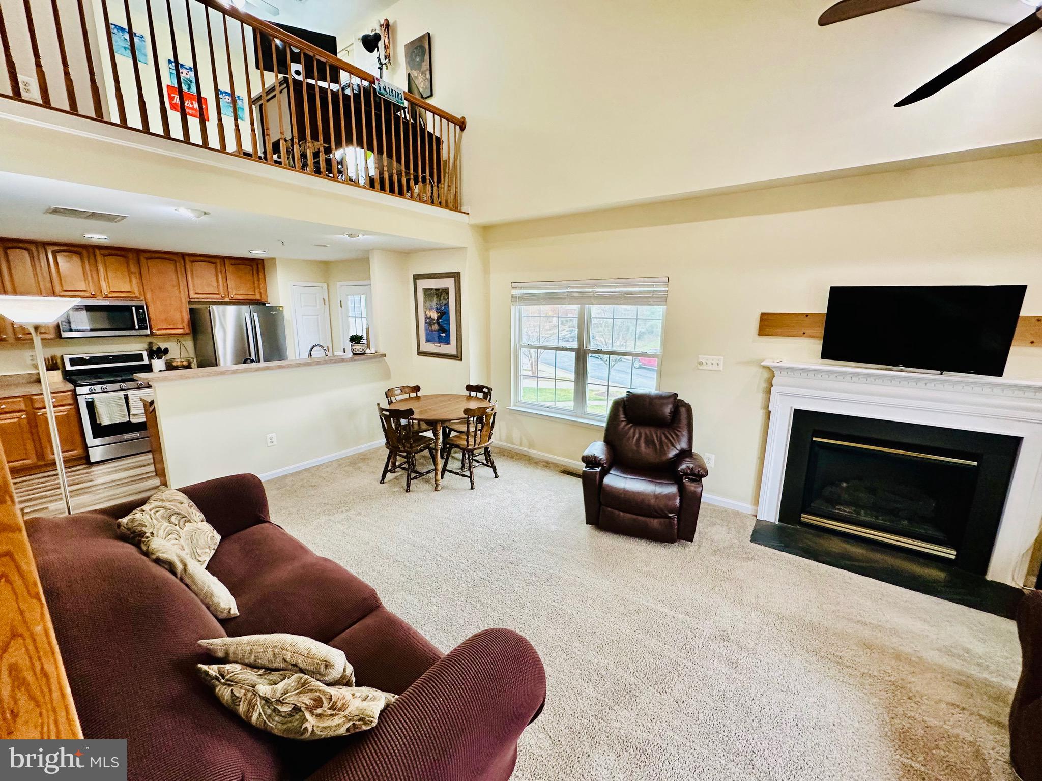 2013 Astilbe Way, Unit 2013 Odenton, MD 21113 - Photo 17 of 61 a living room with furniture a fireplace and a flat screen tv