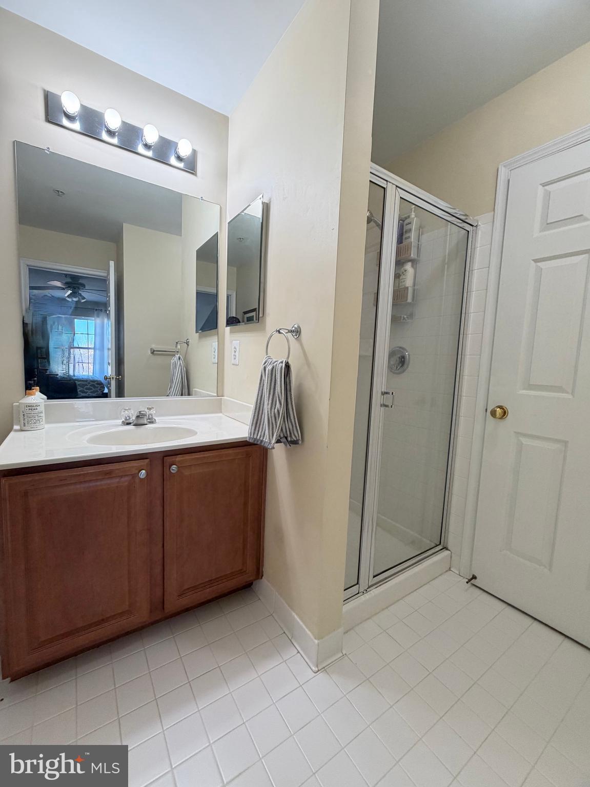 2013 Astilbe Way, Unit 2013 Odenton, MD 21113 - Photo 38 of 61 a bathroom with a double vanity sink and mirror