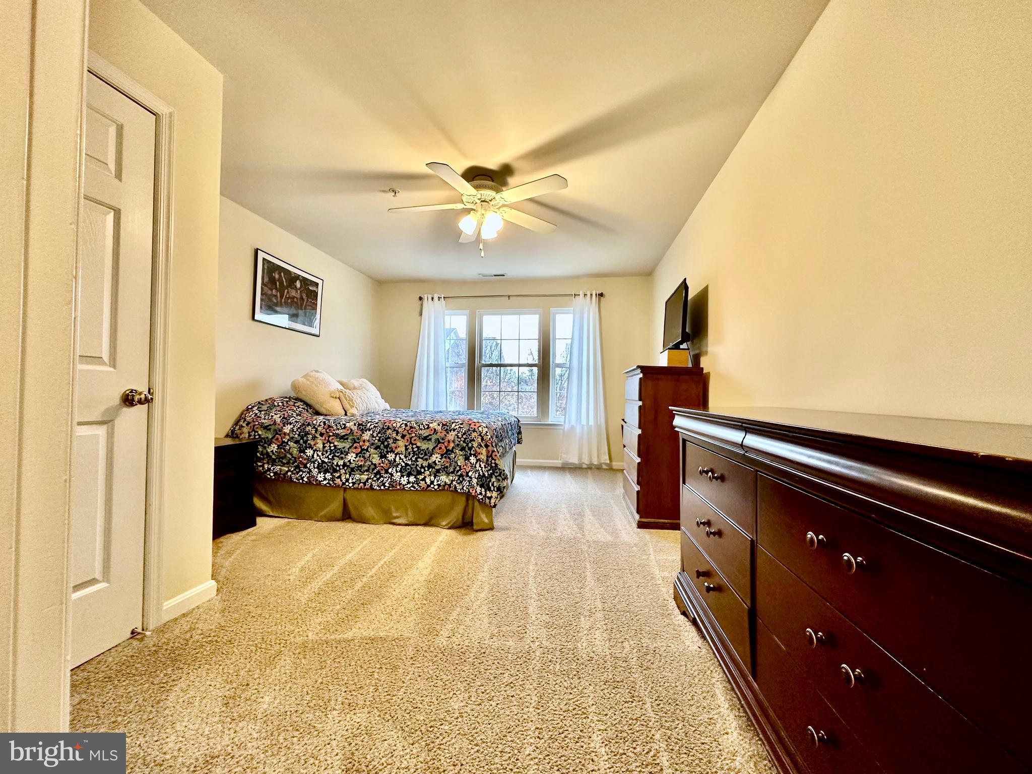 2013 Astilbe Way, Unit 2013 Odenton, MD 21113 - Photo 41 of 61 a bed room with a bed and a chandelier