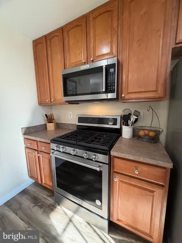 a kitchen with granite countertop cabinets stainless steel appliances and wooden cabinets